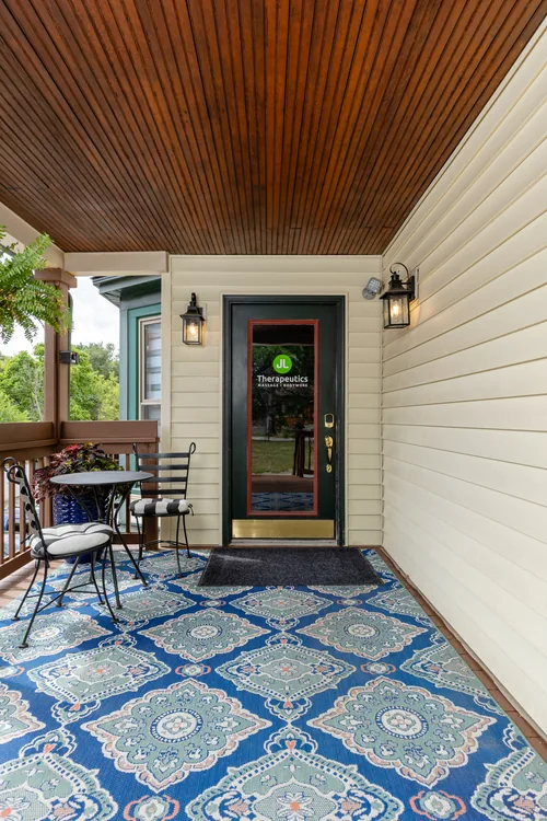 The front entrance on Walnut Boulevard, with covered porch seating